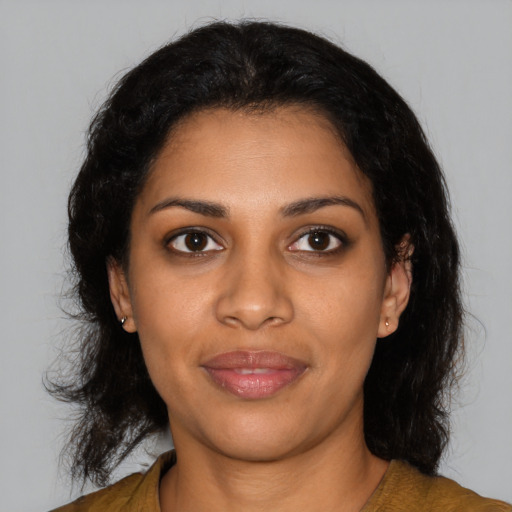 Joyful black young-adult female with medium  brown hair and brown eyes
