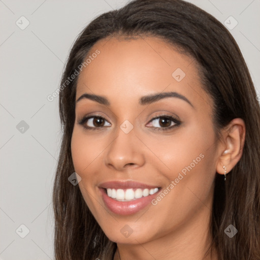 Joyful latino young-adult female with long  brown hair and brown eyes