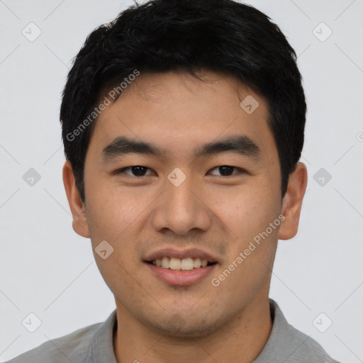 Joyful asian young-adult male with short  black hair and brown eyes