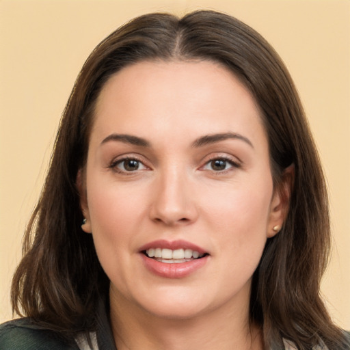 Joyful white young-adult female with long  brown hair and brown eyes