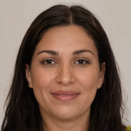 Joyful white adult female with long  brown hair and brown eyes