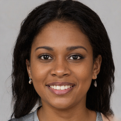 Joyful black young-adult female with medium  brown hair and brown eyes