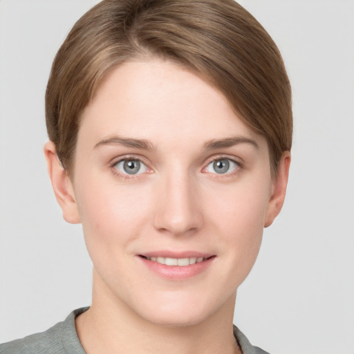 Joyful white young-adult female with short  brown hair and grey eyes