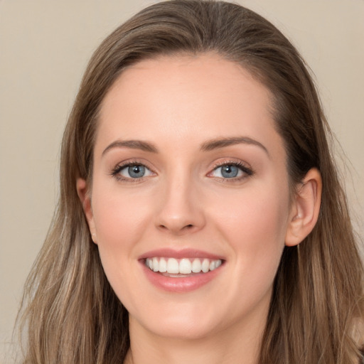 Joyful white young-adult female with long  brown hair and grey eyes