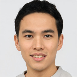 Joyful asian young-adult male with short  black hair and brown eyes