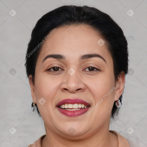 Joyful latino adult female with medium  brown hair and brown eyes