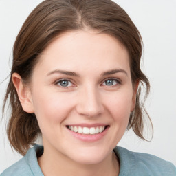 Joyful white young-adult female with medium  brown hair and blue eyes