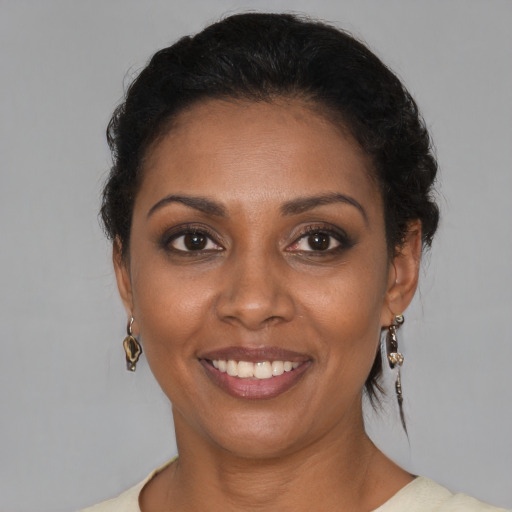 Joyful black young-adult female with short  brown hair and brown eyes