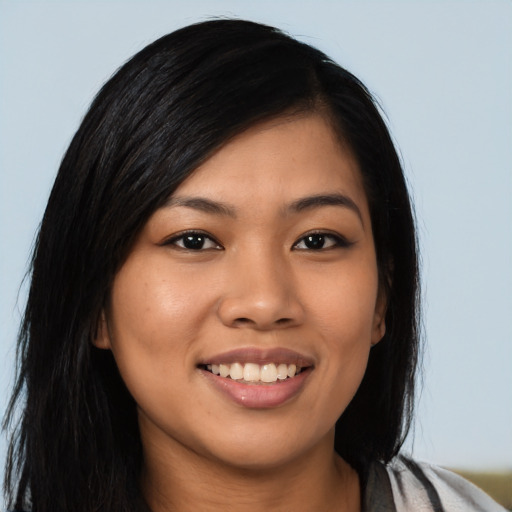 Joyful latino young-adult female with long  black hair and brown eyes