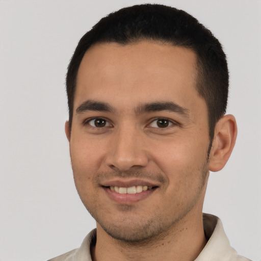 Joyful latino young-adult male with short  black hair and brown eyes