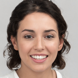 Joyful white young-adult female with medium  brown hair and brown eyes