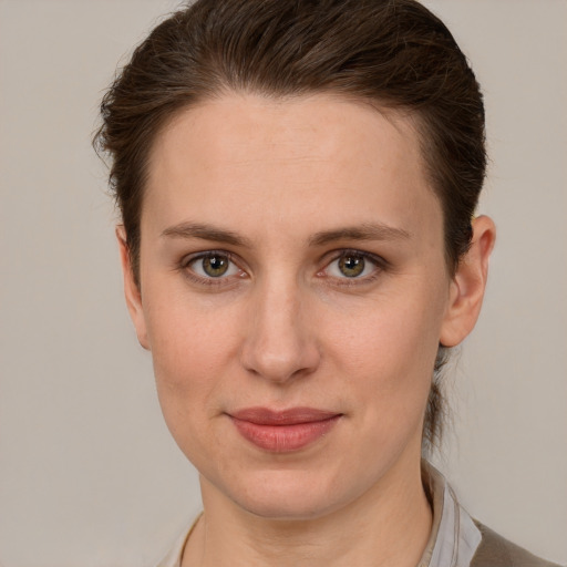 Joyful white young-adult female with short  brown hair and grey eyes