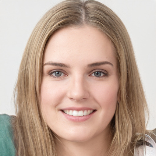 Joyful white young-adult female with long  brown hair and green eyes