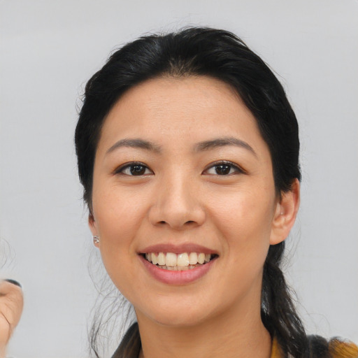 Joyful latino young-adult female with medium  black hair and brown eyes