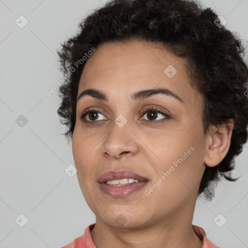 Joyful black young-adult female with short  brown hair and brown eyes