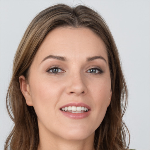 Joyful white young-adult female with long  brown hair and brown eyes