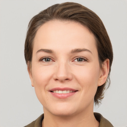 Joyful white young-adult female with medium  brown hair and brown eyes