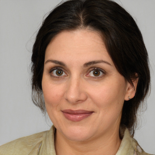 Joyful white adult female with medium  brown hair and brown eyes