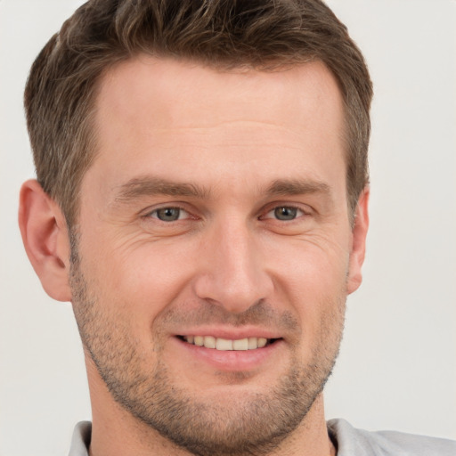 Joyful white young-adult male with short  brown hair and brown eyes