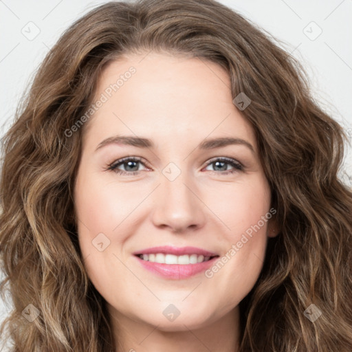 Joyful white young-adult female with long  brown hair and green eyes