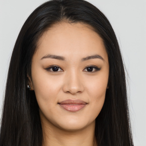 Joyful asian young-adult female with long  black hair and brown eyes