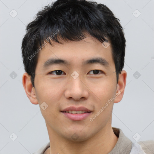 Joyful asian young-adult male with short  brown hair and brown eyes