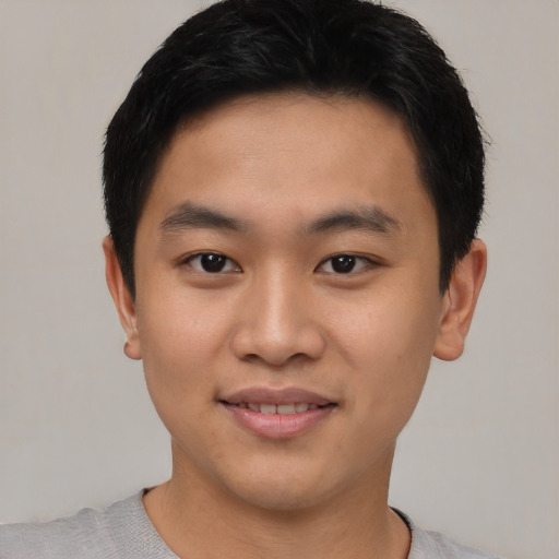 Joyful asian young-adult male with short  black hair and brown eyes