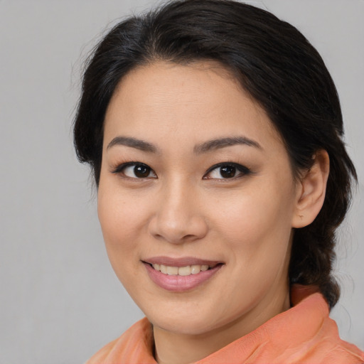 Joyful latino young-adult female with medium  brown hair and brown eyes