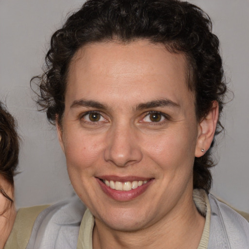 Joyful white adult female with short  brown hair and brown eyes