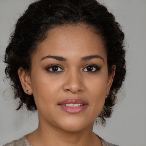 Joyful latino young-adult female with medium  brown hair and brown eyes