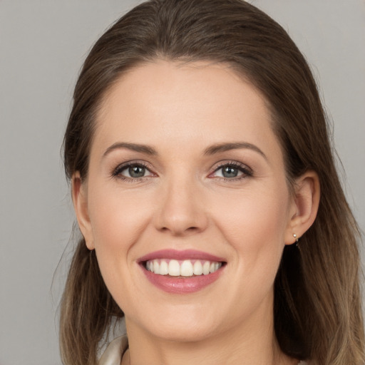 Joyful white young-adult female with long  brown hair and brown eyes