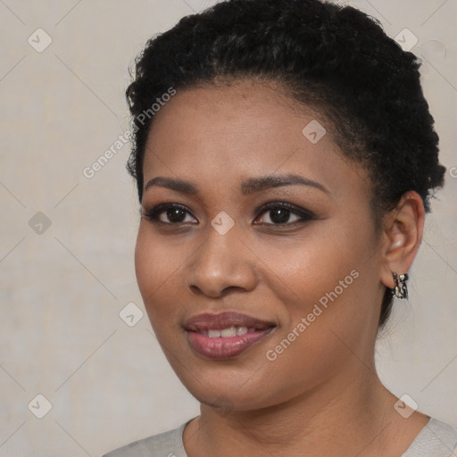 Joyful black young-adult female with short  black hair and brown eyes