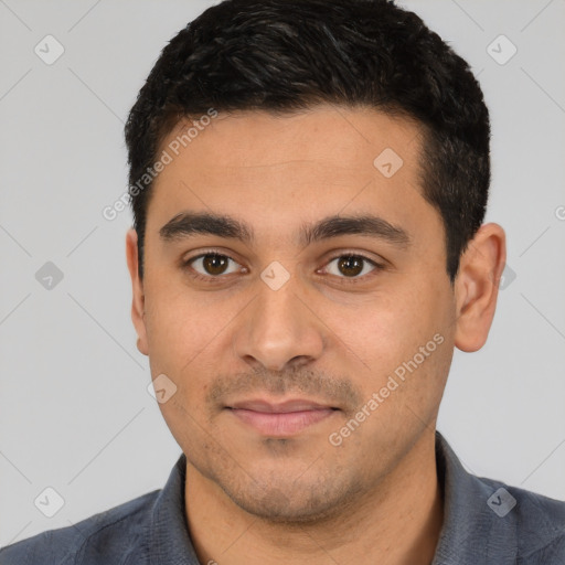 Joyful latino young-adult male with short  black hair and brown eyes