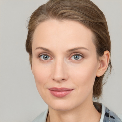 Joyful white young-adult female with medium  brown hair and blue eyes