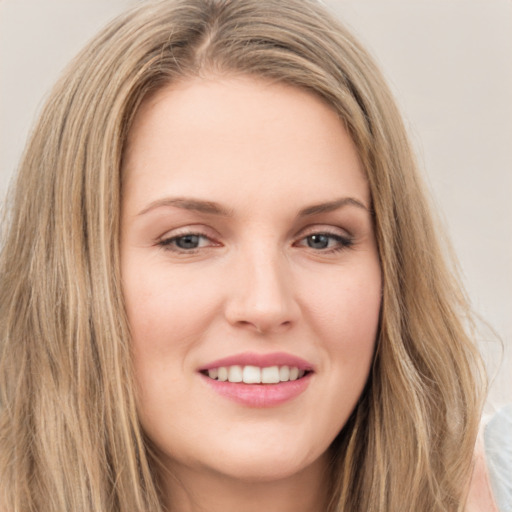 Joyful white young-adult female with long  brown hair and green eyes