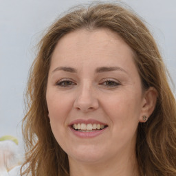 Joyful white adult female with long  brown hair and brown eyes