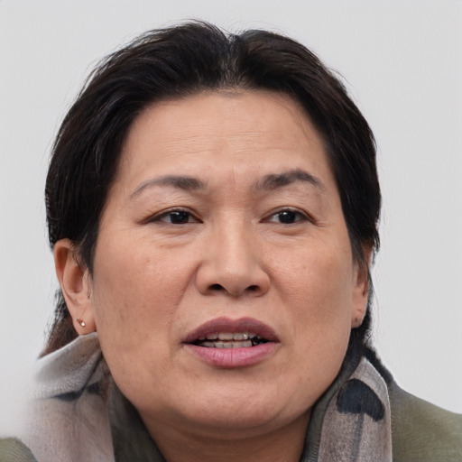 Joyful asian adult female with medium  brown hair and brown eyes