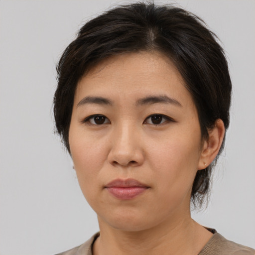 Neutral asian adult female with medium  brown hair and brown eyes