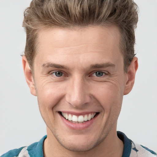 Joyful white adult male with short  brown hair and grey eyes