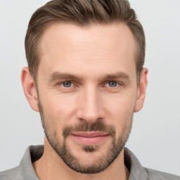 Joyful white young-adult male with short  brown hair and grey eyes