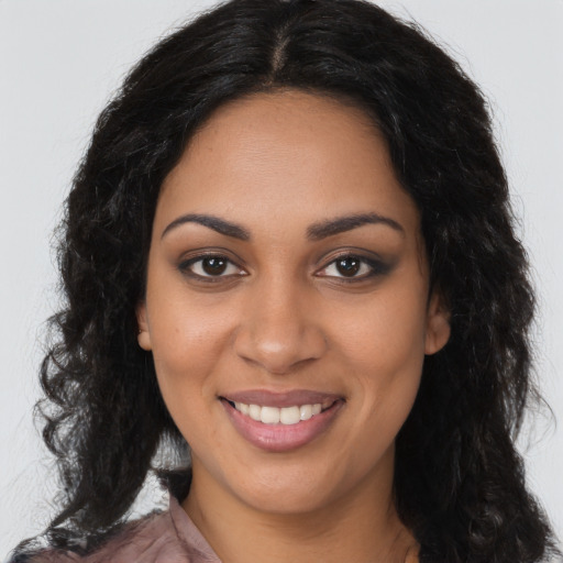 Joyful latino young-adult female with long  brown hair and brown eyes