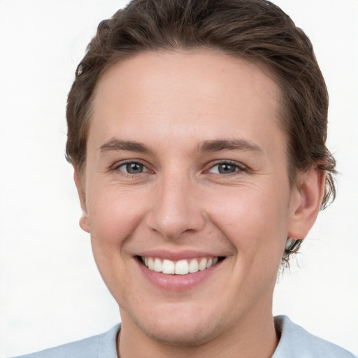 Joyful white young-adult female with short  brown hair and grey eyes