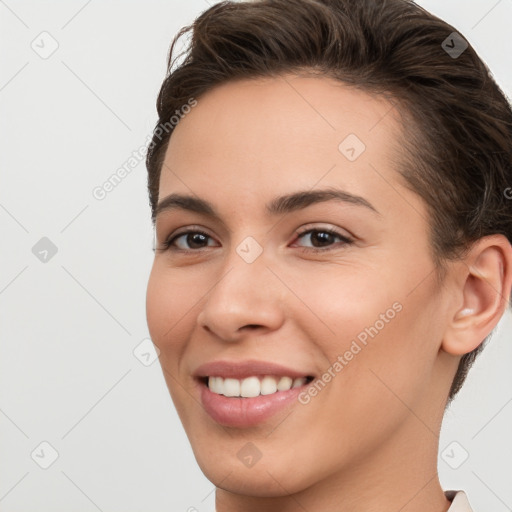 Joyful white young-adult female with short  brown hair and brown eyes