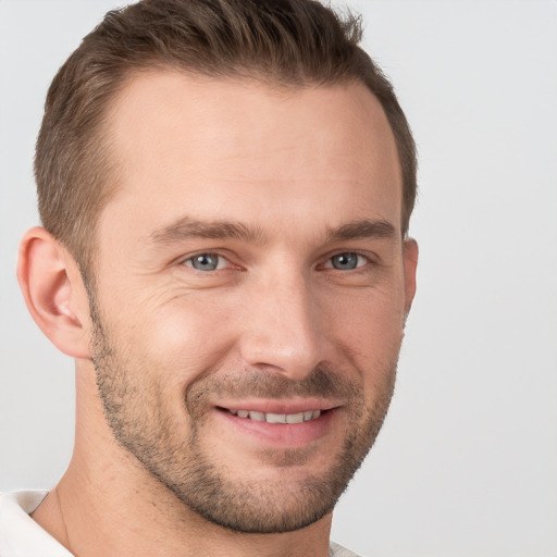 Joyful white young-adult male with short  brown hair and brown eyes