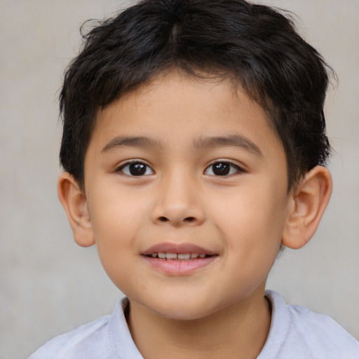 Joyful latino child male with short  brown hair and brown eyes