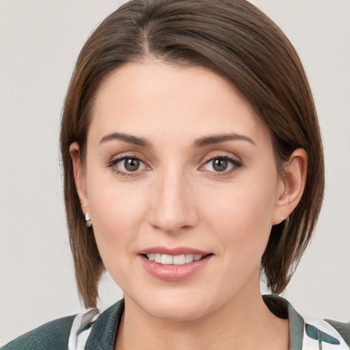 Joyful white young-adult female with medium  brown hair and grey eyes