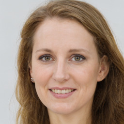 Joyful white young-adult female with long  brown hair and green eyes