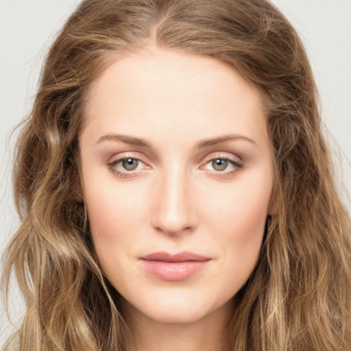 Joyful white young-adult female with long  brown hair and green eyes