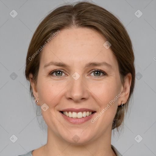 Joyful white adult female with medium  brown hair and grey eyes