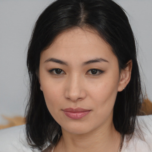 Joyful asian young-adult female with medium  brown hair and brown eyes